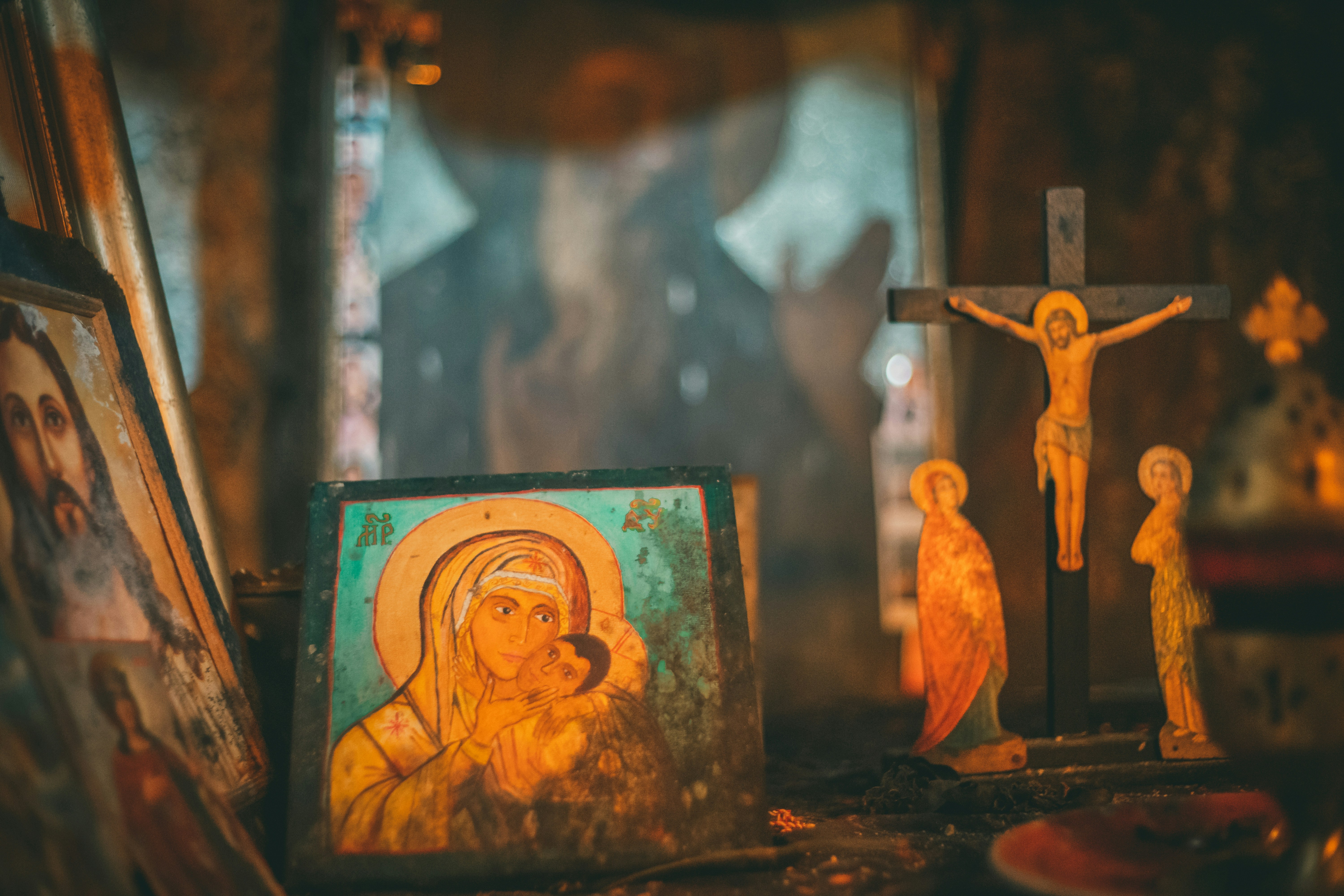 Orthodox icons and a wooden crucifix lit by candlelight